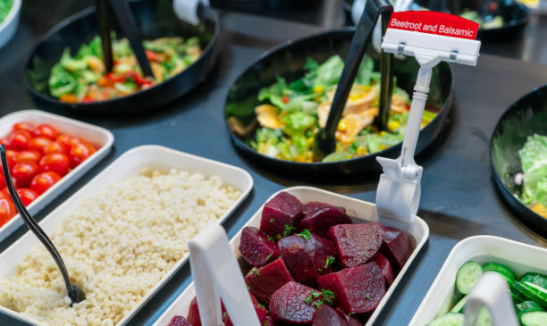 Salad bar buffet at restaurant. Fresh salad bar buffet for lunch or dinner. Healthy food. Beetroot and balsamic in bowl on counter. Catering food. Vegetarian food. Healthy eating. Plant-based diet.