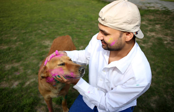 istock Pet owner playing Holi with dog 1309890566