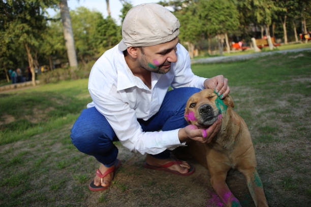 istock Pet owner playing Holi with dog 1309890567