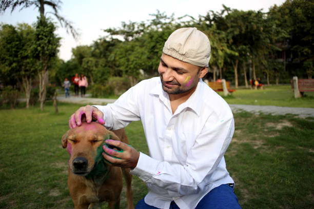 istock Pet owner playing Holi with dog 1309890571