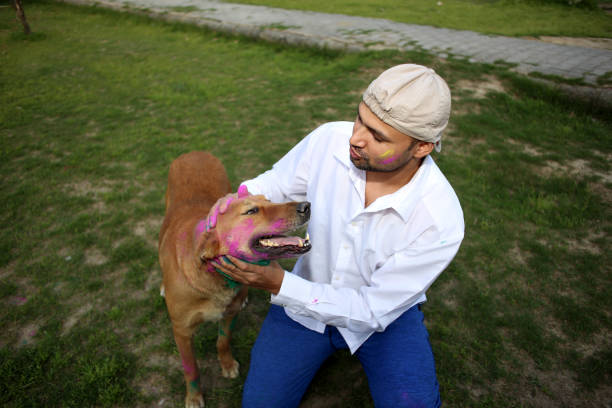 istock Pet owner playing Holi with dog 1309890572