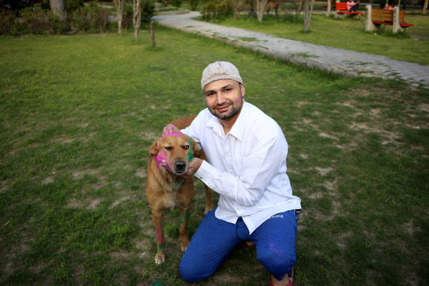 istock Pet owner playing Holi with dog 1309890804