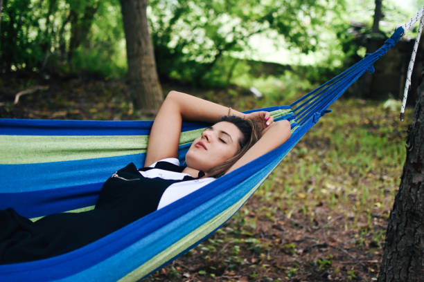istock Beautiful woman enjoying in hammock 1309891568