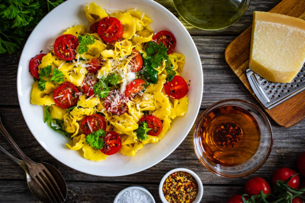 istock Tortellini stuffed with prosciutto ham and vegetables on wooden table 1309894498