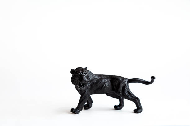 istock Black tiger toy isolated on white background. 1309894553