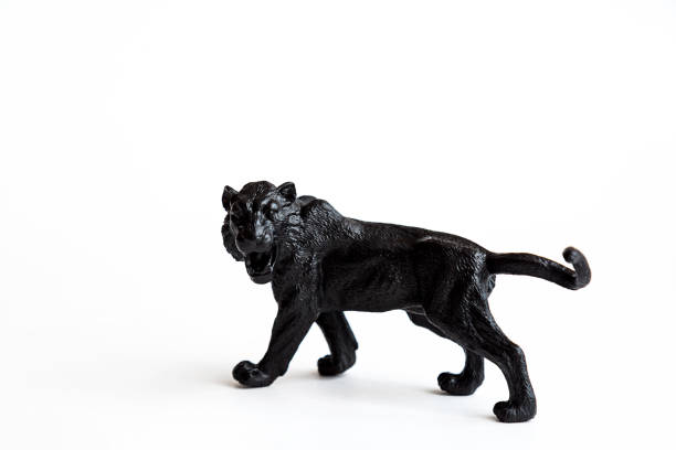 istock Black tiger toy isolated on white background. 1309894555