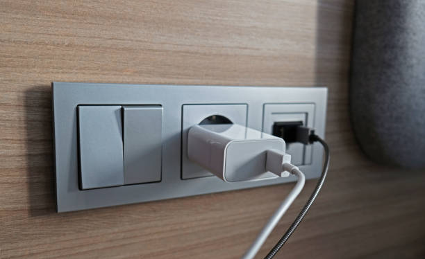 istock Electrical power socket, usb socket, light switch on the wood panel in the interior of the hotel. For convenience, the mobile charger or smartphone in the concept of modern life. Close up. 1309896198