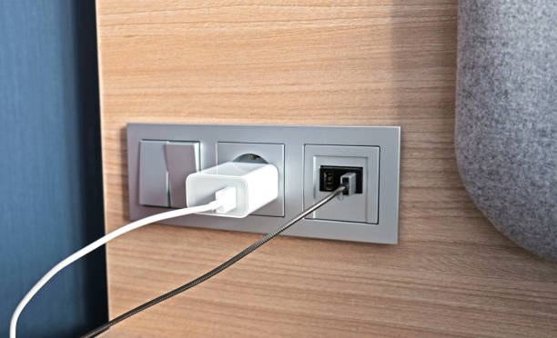 istock Electrical power socket, usb socket, light switch on the wood panel in the interior of the hotel. For convenience, the mobile charger or smartphone in the concept of modern life. Close up. 1309896205