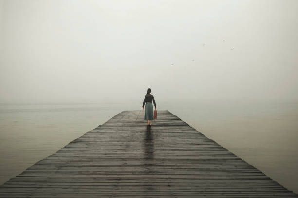 istock woman with suitcase walks towards her destiny 1309896657