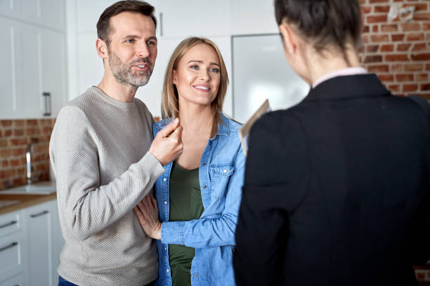 istock Couple talking to a real estate agent 1309897210