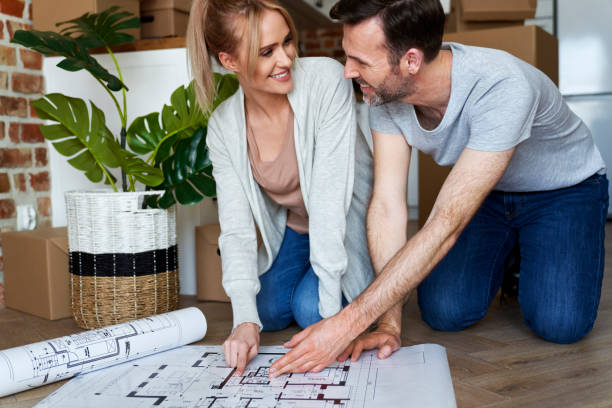 istock Couple discusses a plan for a new apartment 1309897799