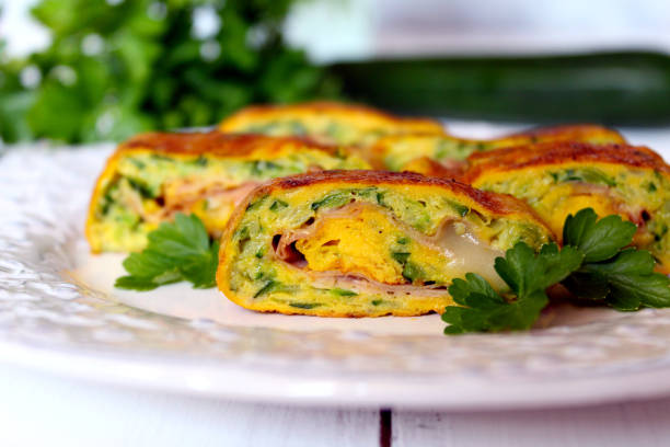 Omelette roll with zucchini, ham and cheese. stock photo