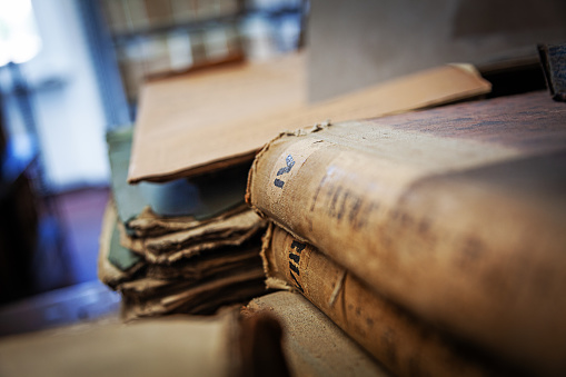 Spines of old books with Roman numerals, on the background documents