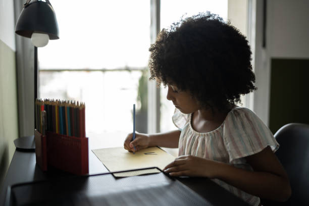 istock Focused girl drawing at home 1309901837