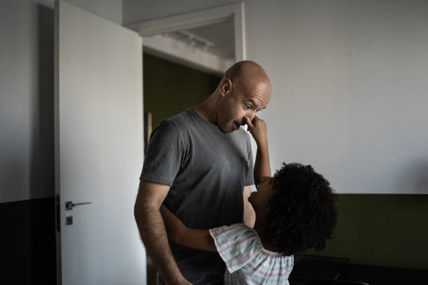 istock Playful girl pulling father's nose at home 1309901846