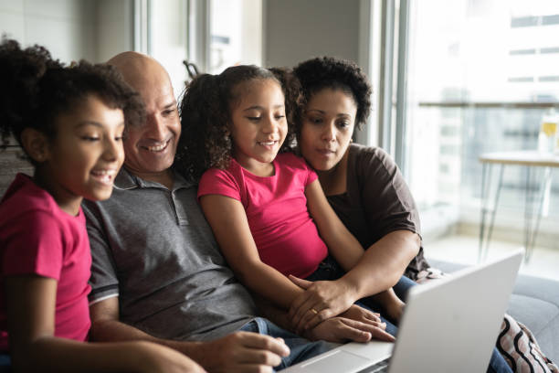istock Family together using laptop at home 1309905504