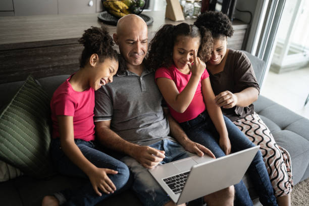 istock Family together using laptop at home 1309905557