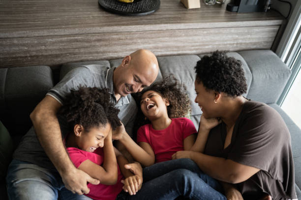 istock Parents tickling daughters at home 1309905580