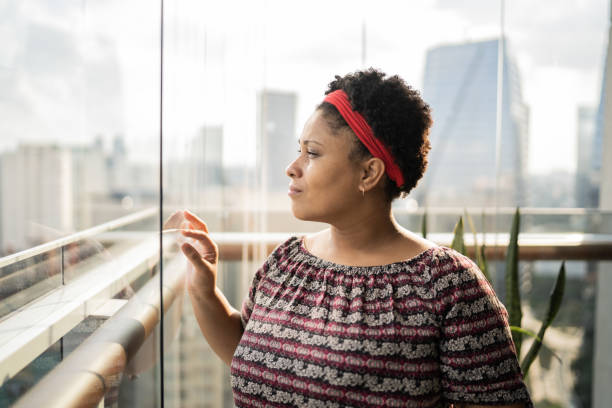 istock Woman looking away at home 1309905587