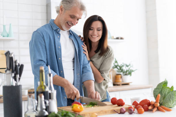 istock Couple cooking together in their kitchen at home. 1309906147
