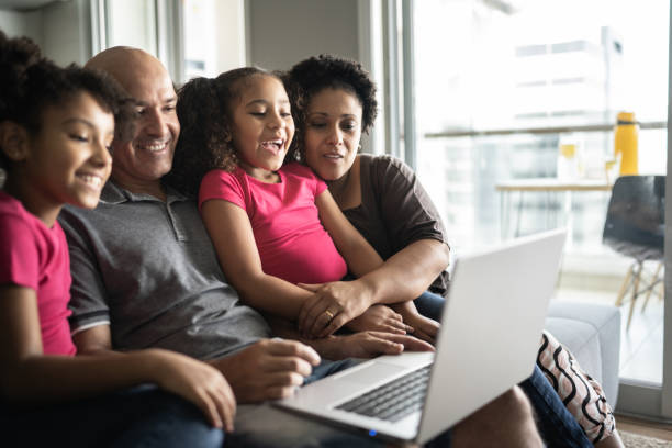 istock Family together using laptop at home 1309906213