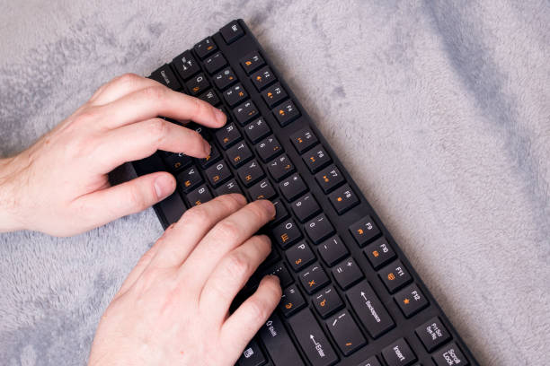 istock Keys on black keyboard and hand closeup 1309907314