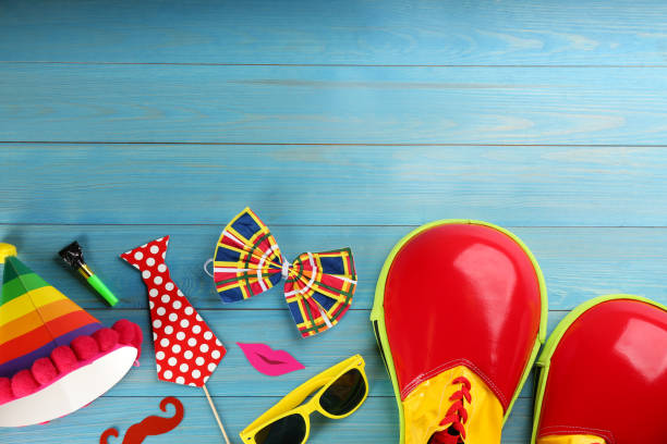 istock Flat lay composition with clown's items on light blue wooden table, space for text 1309907709