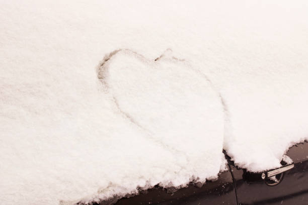 istock Heart painted on snow on car glass 1309907737