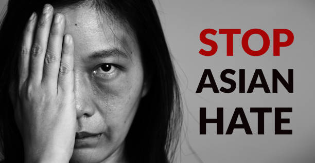 stop asian hate campaign. asia woman with bruise on arms and face, raise one hand and cover one face side. word stop asian hate at copy space for poster of campaign. - anti racism imagens e fotografias de stock
