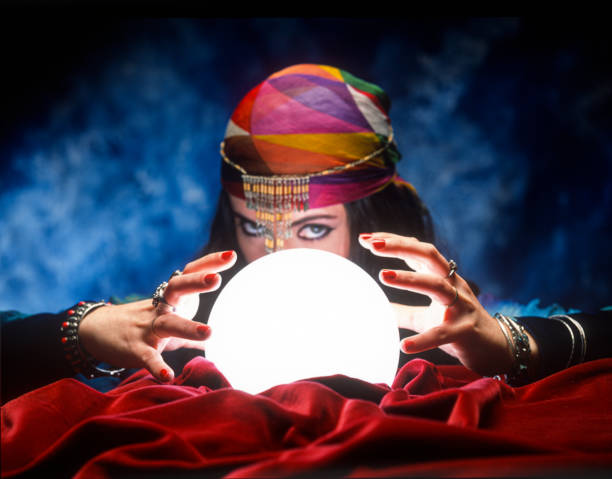 istock fortune teller with glowing crystal ball 1309914504