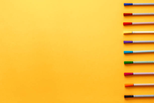 istock A blank yellow background with place for text. Copy space. Colorful markers arranged in a row. 1309916240
