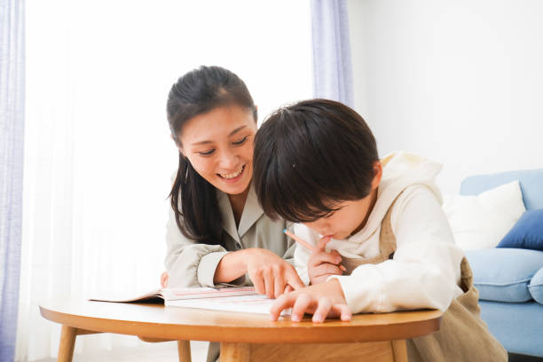 istock A boy studying with his mother at home 1309917377