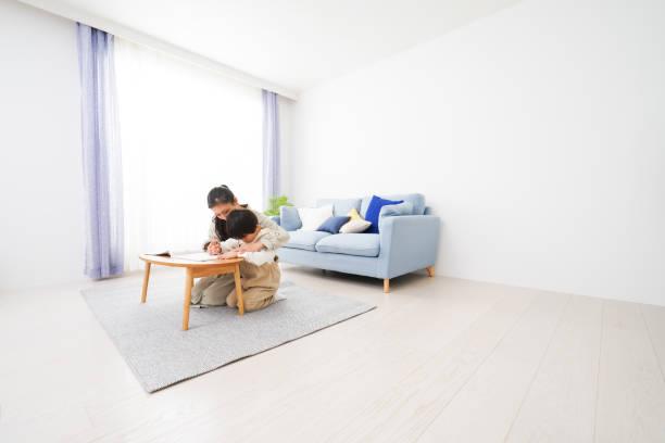 istock A boy studying with his mother at home 1309917390
