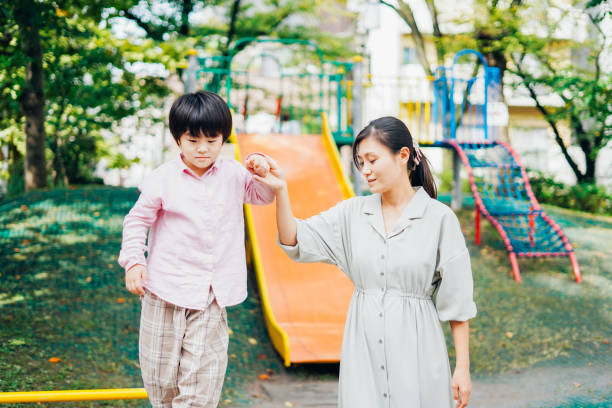 istock A boy playing with his mother at the park 1309919134