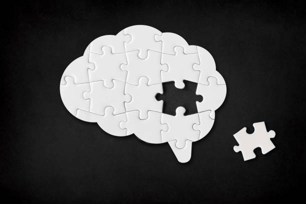istock Brain shaped white jigsaw puzzle on black background, a missing piece of the brain puzzle, mental health and problems with memory 1309919962