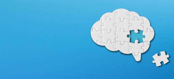 istock Brain shaped white jigsaw puzzle with copy space on blue background, a missing piece of the brain puzzle, mental health and problems with memory 1309919978
