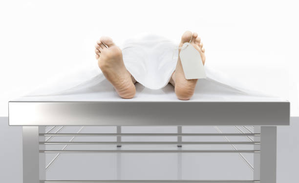 Dead body Corpse at the coroner table at the morgue morgue stock pictures, royalty-free photos & images