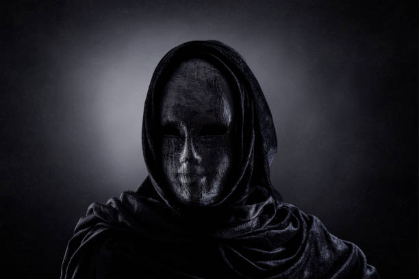 istock Scary figure with hooded cape in the dark 1309923510
