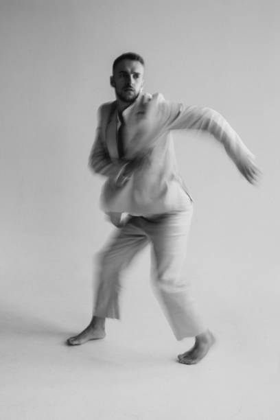 istock Portrait of a dancing guy with blurred background and long exposure. Black and white photography 1309923556