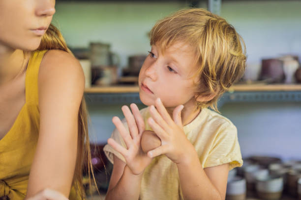 istock mother and son doing ceramic pot in pottery workshop 1309924104