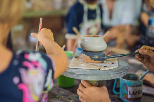 istock mother and son doing ceramic pot in pottery workshop 1309924140