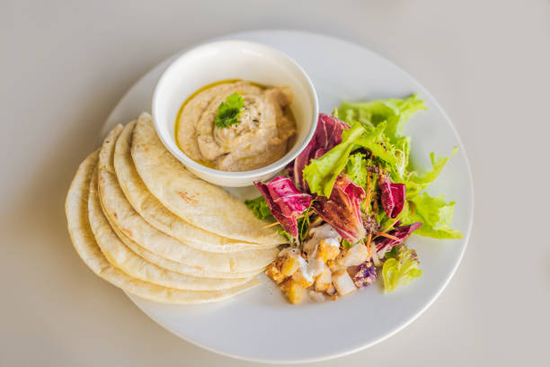 istock Hummus with tortillas on a white table 1309924160