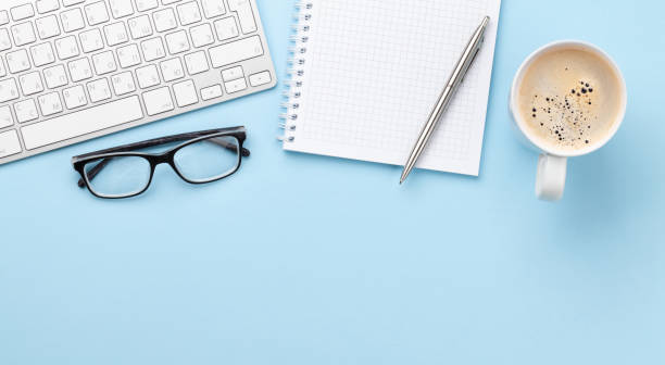 istock Office desk with supplies, coffee and blank notepad 1309924173