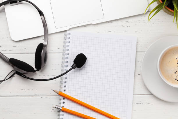 istock Office desk with headset and laptop. Work from home 1309924187