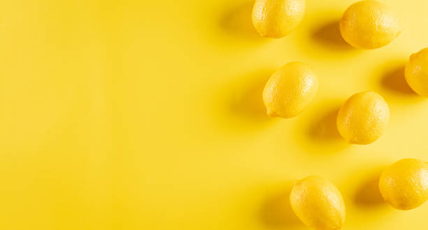 Top view of fresh lemon on pastel yellow background. Food concept. Flat lay, top view, copy space