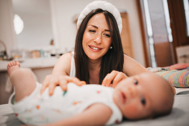 istock Happy mother playing with her baby 1309926543