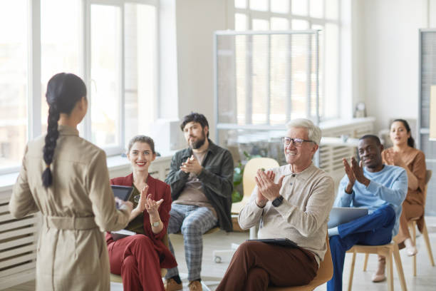 istock Audience Applauding to Female Speaker 1309928290