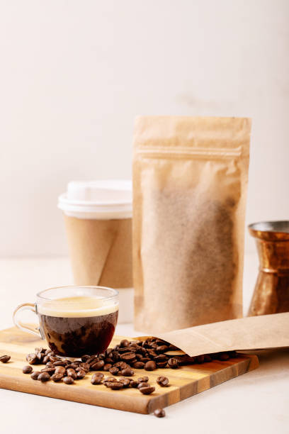 istock Take away paper cup of coffee and blank coffee packs 1309929897