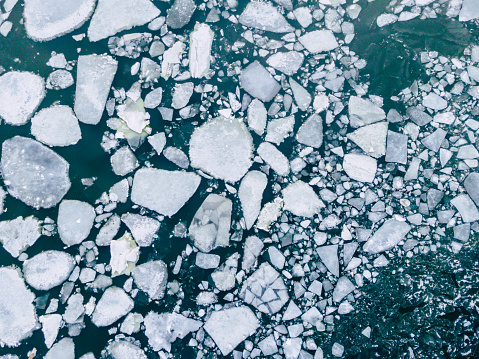 This pic show aerial view of frozen sea. Big Cracked ice floe floating on baltic sea in Helsinki finland.