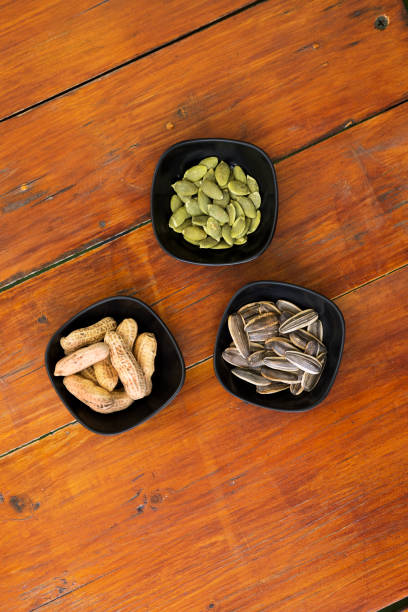 View onto three bowls with seeds and nuts